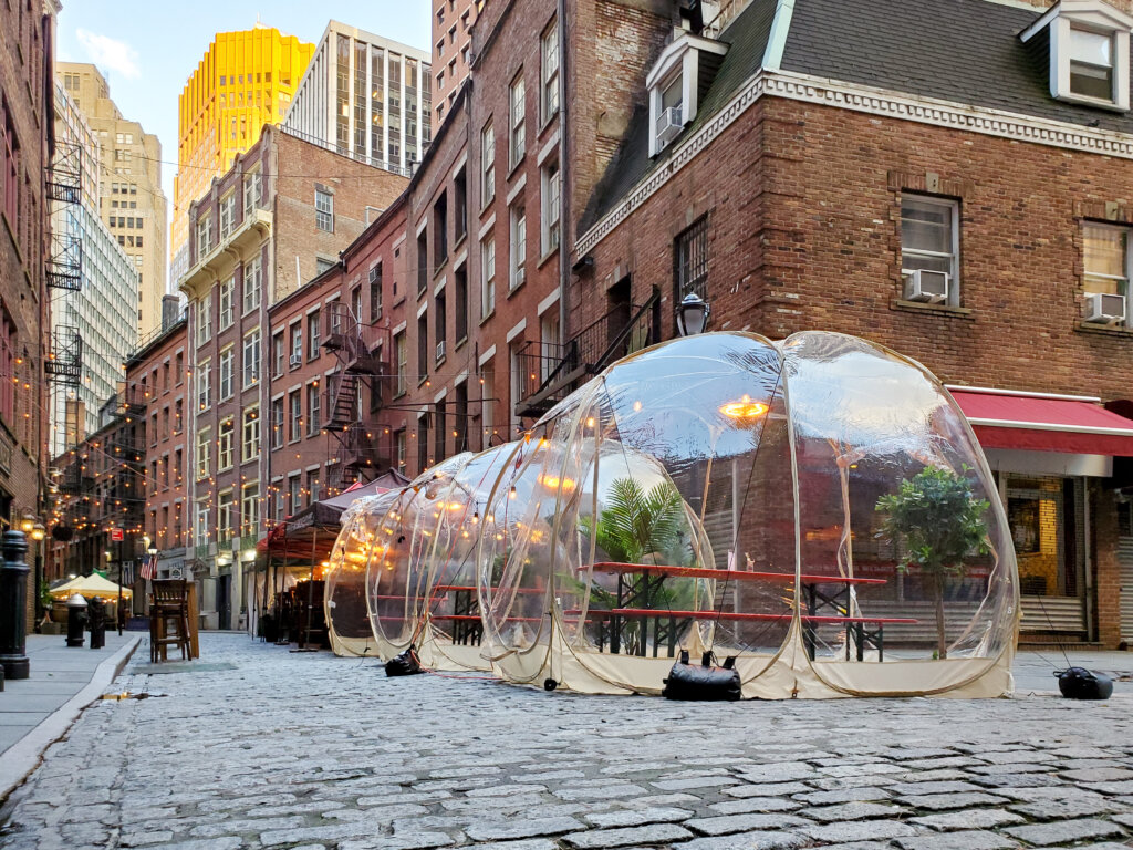 Outdoor dining tables in bubbles along Stone Street during the coronavirus pandemic in downtown Manhattan, New York City NYC