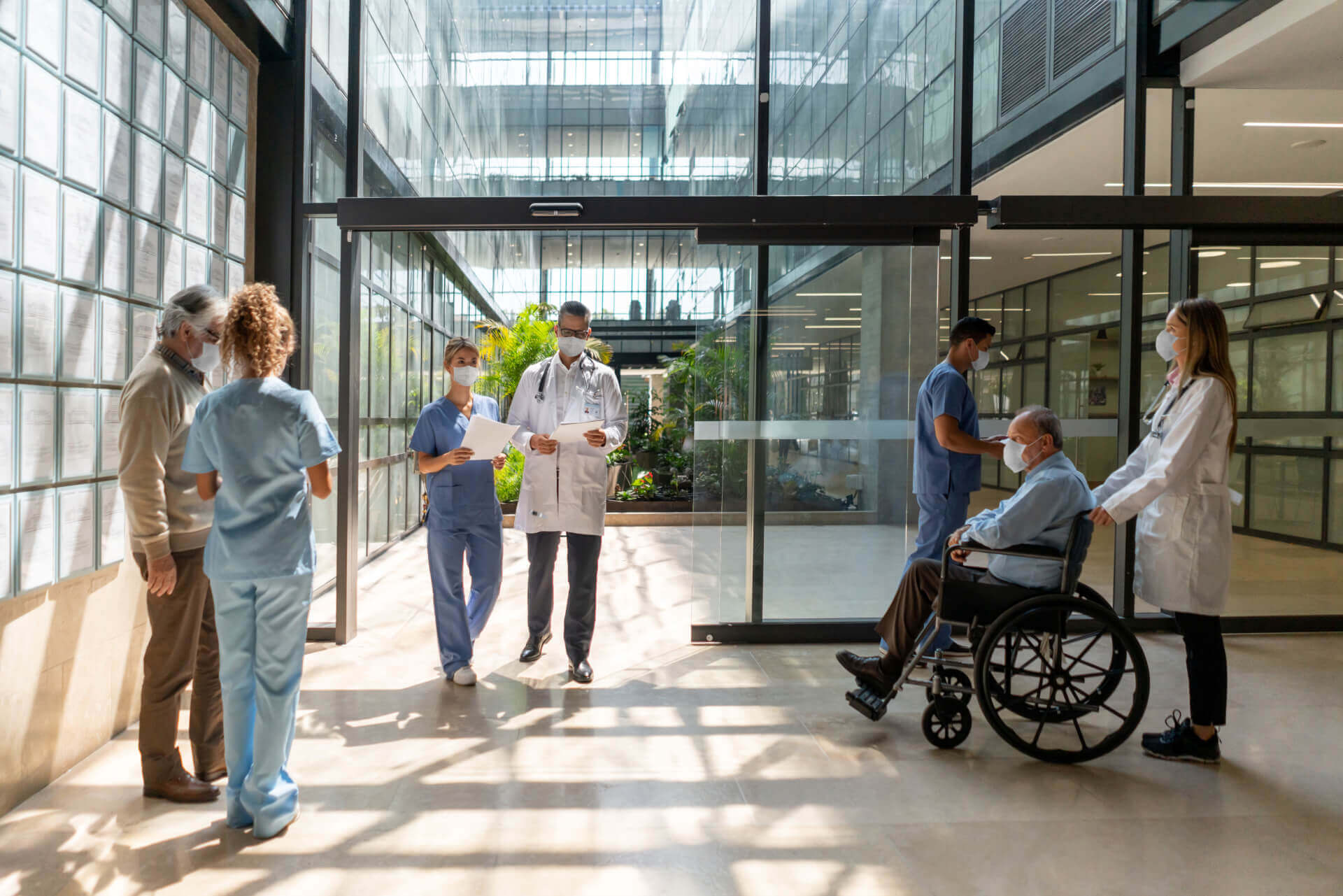 people walking through a hospital