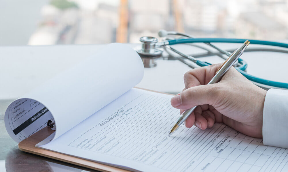 A patient filling out a discharge form.