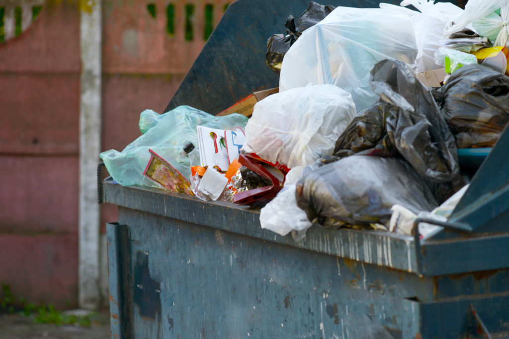 overflowing dumpster creating foul odors at your business