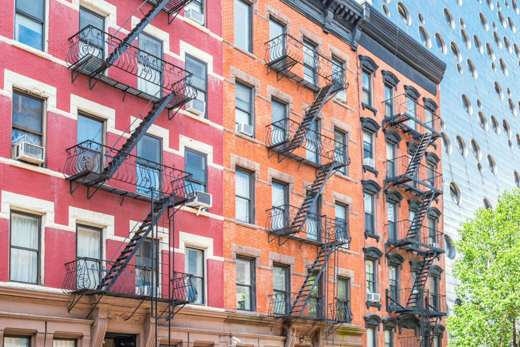 Typical apartments and fire escape ladders in Chelsea, Manhattan, New York City USA.