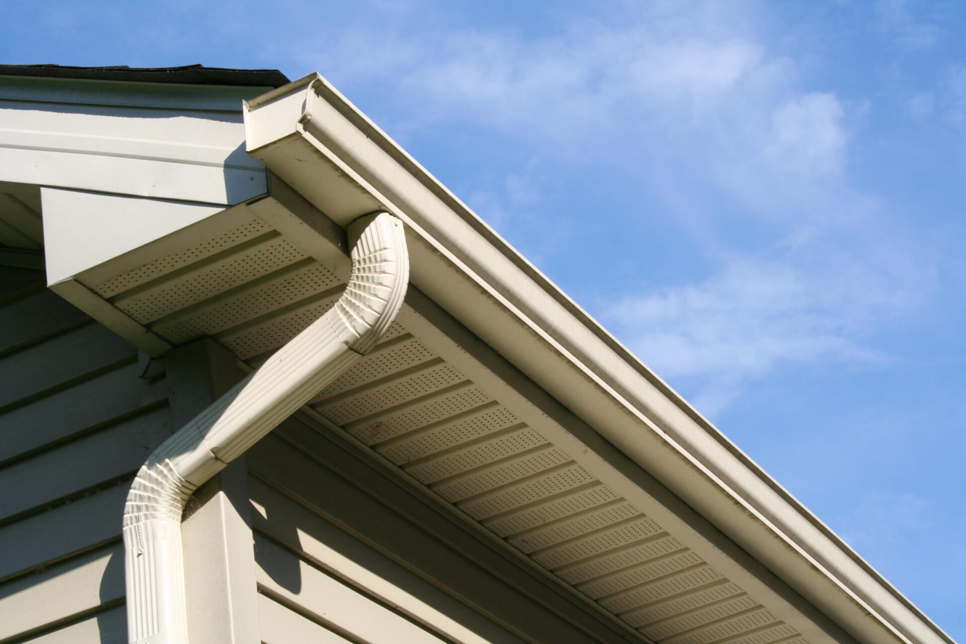 Angled view of gutter and downspout on a house
